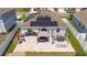 Aerial view of a beautiful patio complete with outdoor dining, lounge furniture, and a grill at 6935 Dilly Lake Ave, Groveland, FL 34736
