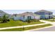 Well-maintained home with a green lawn, white fence, and neat landscaping at 6935 Dilly Lake Ave, Groveland, FL 34736