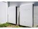Close-up of a pair of Tesla Powerwall batteries against the textured exterior of the home at 6935 Dilly Lake Ave, Groveland, FL 34736