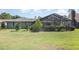 Expansive backyard featuring a screened-in pool area, lush green lawn, and mature landscaping for privacy at 71 Lazy Eight Dr, Port Orange, FL 32128