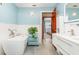Bright bathroom with freestanding tub, modern vanity, and view to bedroom, creating a spa-like atmosphere at 71 Lazy Eight Dr, Port Orange, FL 32128