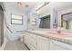 Classic bathroom with double sinks, white tile, and a shower with glass doors at 71 Lazy Eight Dr, Port Orange, FL 32128