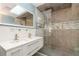 Stylish bathroom featuring double sinks, modern fixtures, and a glass-enclosed shower with sleek tile work at 71 Lazy Eight Dr, Port Orange, FL 32128