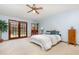 Spacious bedroom featuring a king bed and access to a private outdoor pool at 71 Lazy Eight Dr, Port Orange, FL 32128