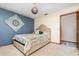Serene bedroom with a bed, blue accent wall, and wood door, providing a comfortable retreat at 71 Lazy Eight Dr, Port Orange, FL 32128