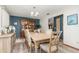 Inviting dining room with hardwood floors, a large hutch, and stylish light fixture at 71 Lazy Eight Dr, Port Orange, FL 32128