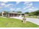Exterior of home with a brick driveway and well-maintained lawn and mature landscaping at 71 Lazy Eight Dr, Port Orange, FL 32128