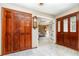 Spacious foyer featuring tile flooring, a coat closet, and a view into the living room with a ceiling fan at 71 Lazy Eight Dr, Port Orange, FL 32128