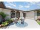 Close-up of the home's entrance showcasing the front patio, brick facade, and well-maintained landscaping at 71 Lazy Eight Dr, Port Orange, FL 32128