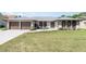 Charming single-story home featuring a brick facade, well-manicured lawn, and a cozy front patio at 71 Lazy Eight Dr, Port Orange, FL 32128