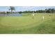 Picture of the golf course, green grass and a small pond can be seen on this sunny day at 71 Lazy Eight Dr, Port Orange, FL 32128