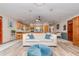 Open-concept living space showcasing hardwood floors, a comfortable sofa, and seamless access to the kitchen at 71 Lazy Eight Dr, Port Orange, FL 32128