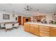 Open-concept living and dining area with brick fireplace and modern lighting fixtures at 71 Lazy Eight Dr, Port Orange, FL 32128