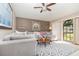 Bright and inviting living room with a comfortable sectional sofa, patterned rug, and large windows at 71 Lazy Eight Dr, Port Orange, FL 32128