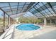 Enclosed pool area with an awning, providing a private and comfortable space for recreation and relaxation at 71 Lazy Eight Dr, Port Orange, FL 32128