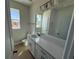 Bathroom features double sinks, a large mirror, and great natural lighting from the window at 738 Pointe Emerson Blvd, Apopka, FL 32703