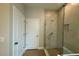 Bathroom featuring a glass-enclosed shower and tiled walls at 738 Pointe Emerson Blvd, Apopka, FL 32703