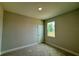Cozy bedroom with a neutral color scheme and a window overlooking the outdoors at 738 Pointe Emerson Blvd, Apopka, FL 32703