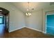 Inviting dining room featuring wood-look flooring and a stylish chandelier at 738 Pointe Emerson Blvd, Apopka, FL 32703