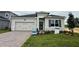 Charming single-story home with a two-car garage, featuring a well-maintained lawn and inviting front entrance at 738 Pointe Emerson Blvd, Apopka, FL 32703
