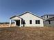 New construction home featuring modern elevation, neutral colors, and well manicured lawn at 738 Pointe Emerson Blvd, Apopka, FL 32703