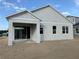 Rear exterior view highlighting the covered porch and multiple windows at 738 Pointe Emerson Blvd, Apopka, FL 32703