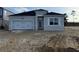 Modern single-story home with gray exterior, attached garage, and spacious front yard under construction at 738 Pointe Emerson Blvd, Apopka, FL 32703