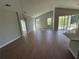 Open living room boasts hardwood flooring, high ceilings, and plenty of natural light at 738 Pointe Emerson Blvd, Apopka, FL 32703