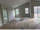 Bright open-concept living room featuring high ceilings and multiple windows, still under construction at 738 Pointe Emerson Blvd, Apopka, FL 32703