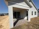 Covered patio with brick flooring and sliding glass doors offers indoor-outdoor living at 738 Pointe Emerson Blvd, Apopka, FL 32703