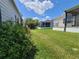 The home features a well-maintained backyard, offering ample green space and a view of the screened patio at 741 Truman Ave, Lady Lake, FL 32159