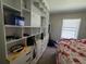Bedroom featuring a wall-to-wall built-in storage and large window for natural light at 741 Truman Ave, Lady Lake, FL 32159
