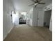 Bright bedroom area with an ensuite bathroom, featuring a ceiling fan for added comfort at 741 Truman Ave, Lady Lake, FL 32159