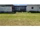 Well-maintained lawn and exterior view of this single Gathering home featuring a screened-in porch and ample lighting at 741 Truman Ave, Lady Lake, FL 32159