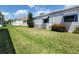The exterior displays the manicured lawn and beautiful landscaping that surrounds this single Gathering home at 741 Truman Ave, Lady Lake, FL 32159