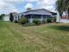 Charming single-story home featuring a well-maintained lawn, mature landscaping, and a bright exterior at 741 Truman Ave, Lady Lake, FL 32159