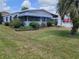 Charming single-story home featuring a well-maintained lawn, mature landscaping, and a bright exterior at 741 Truman Ave, Lady Lake, FL 32159