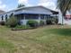 Charming single-story home featuring a well-maintained lawn, mature landscaping, and a bright exterior at 741 Truman Ave, Lady Lake, FL 32159