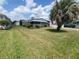 Charming single-story home featuring a well-maintained lawn, mature landscaping, and a bright exterior at 741 Truman Ave, Lady Lake, FL 32159