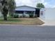 Charming single-story home featuring a well-maintained lawn, mature landscaping, and a bright exterior at 741 Truman Ave, Lady Lake, FL 32159