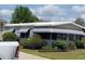 Charming single-story home with awnings and landscaped yard at 741 Truman Ave, Lady Lake, FL 32159