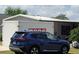 Home exterior with PODS moving container and vehicle at 741 Truman Ave, Lady Lake, FL 32159