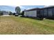 Nice lawn, landscaping and a white horizontal slat fence and carport add charm to this single Gathering home at 741 Truman Ave, Lady Lake, FL 32159