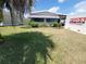 Inviting front yard of this single Gathering home shows the well maintained lawn and landscaping around the home at 741 Truman Ave, Lady Lake, FL 32159