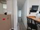 Long hallway featuring wood-look flooring, with a built-in desk and a view of the house at 741 Truman Ave, Lady Lake, FL 32159