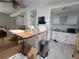 Spacious kitchen area with a butcher block island and white cabinetry, partially packed with moving boxes at 741 Truman Ave, Lady Lake, FL 32159