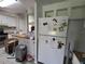 Well-lit kitchen with white cabinets and appliances, and a spacious layout, partially packed with moving boxes at 741 Truman Ave, Lady Lake, FL 32159