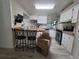Kitchen with a breakfast bar, stainless appliances, and bright cabinets at 741 Truman Ave, Lady Lake, FL 32159