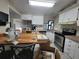 Bright kitchen with stainless appliances, white cabinets, and an eat-in bar at 741 Truman Ave, Lady Lake, FL 32159