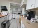 Functional kitchen with white cabinets, laminate countertops, and essential appliances at 741 Truman Ave, Lady Lake, FL 32159
